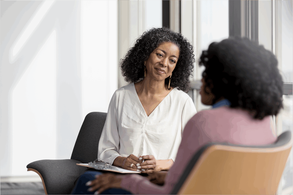 A business leader works with a member of her team in a performance management session