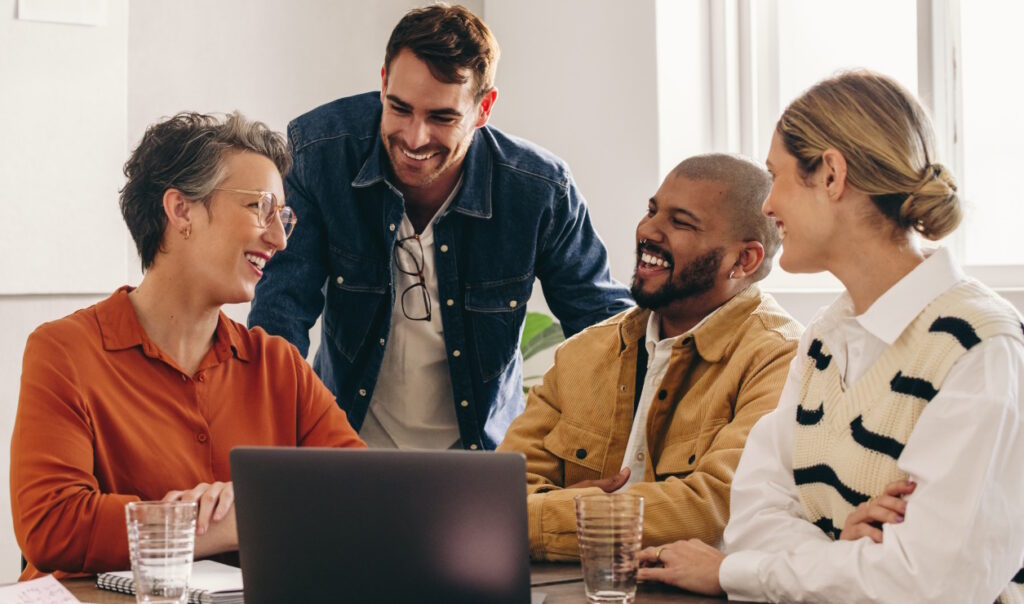 DEI at work: Diverse team working happily together.